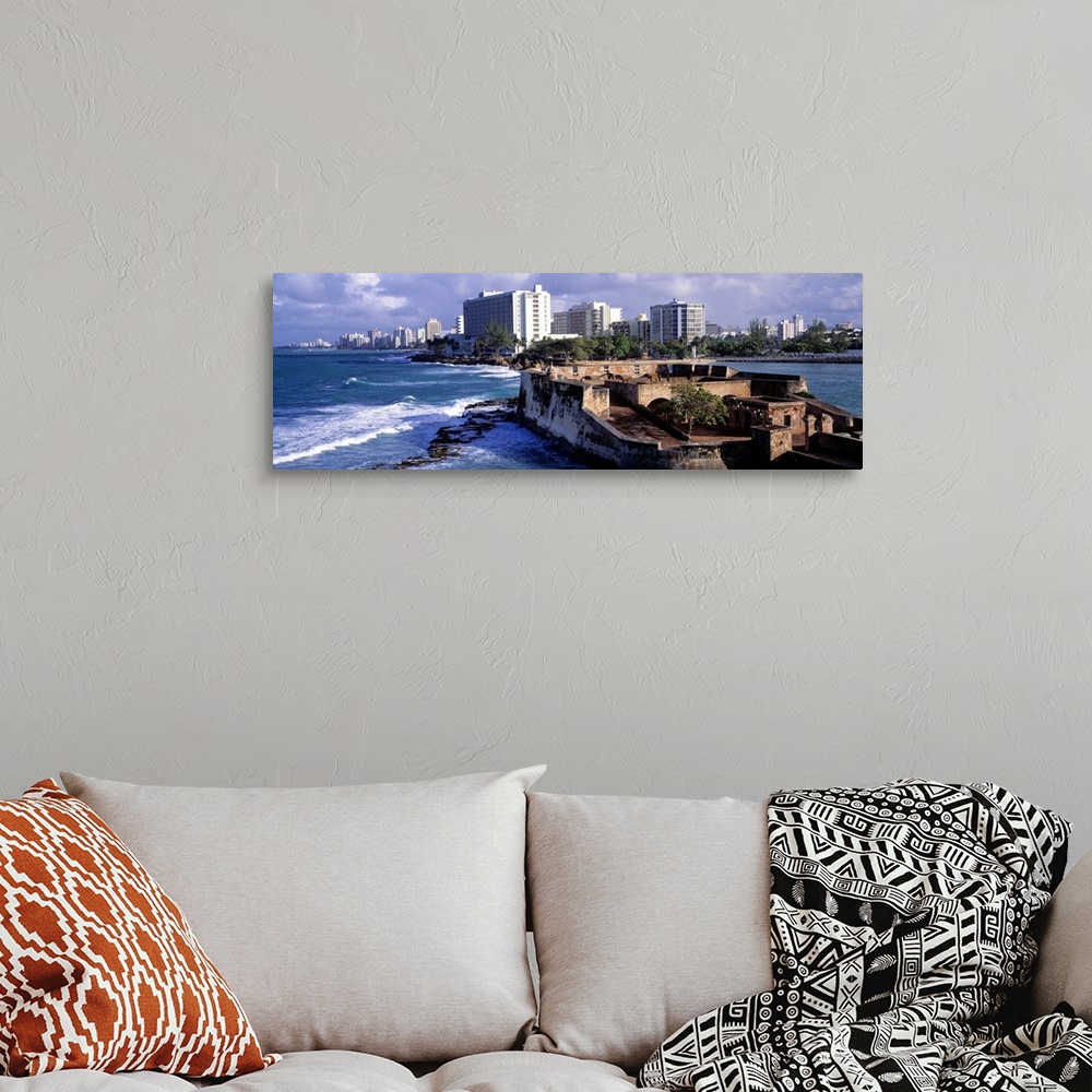 A bohemian room featuring Panoramic photograph of San Jeronimo Fort on the waters of San Juan, the city skyline in the back...