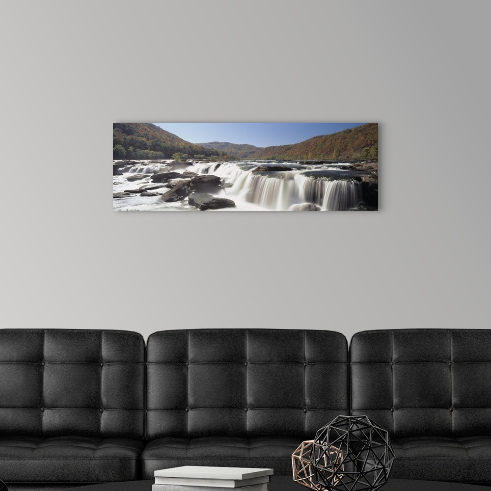 A modern room featuring Panoramic image on canvas of long waterfalls with rolling mountains of fall foliage in the backgr...