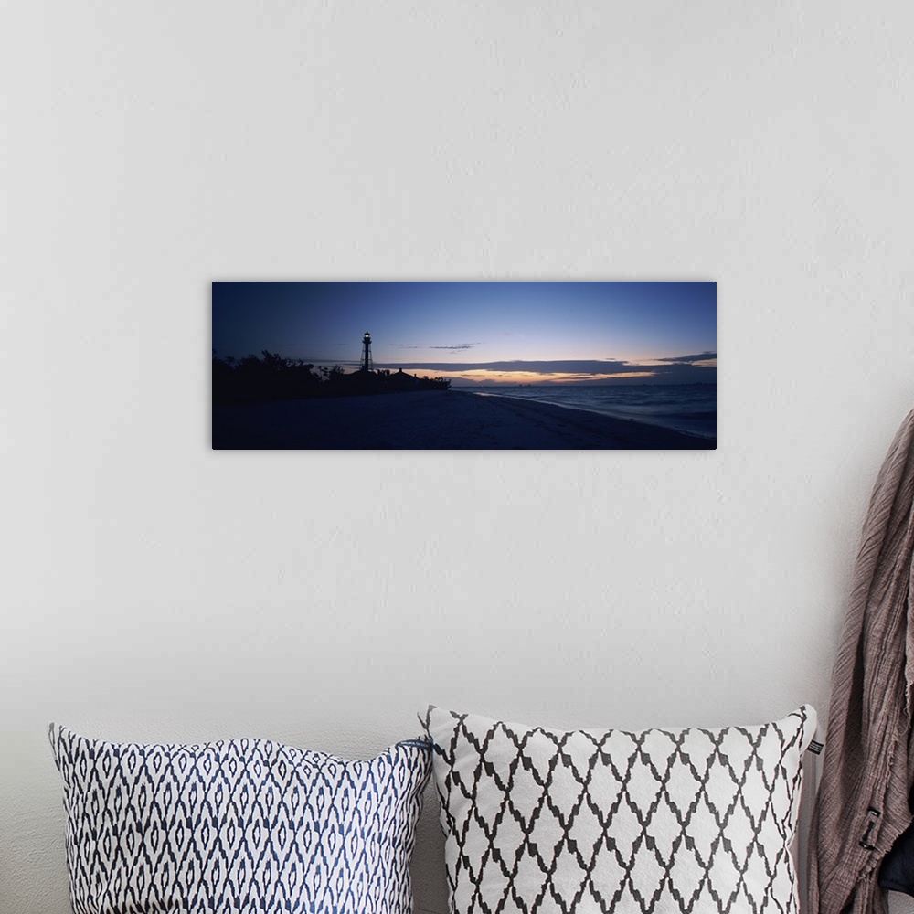 A bohemian room featuring Wide angle photograph on a large canvas of the shoreline at Sanibel Island, in the darkness of ea...