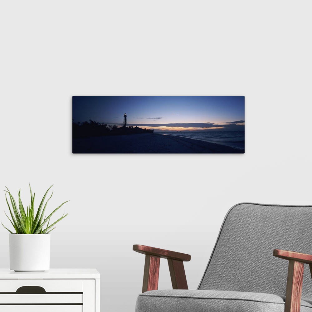 A modern room featuring Wide angle photograph on a large canvas of the shoreline at Sanibel Island, in the darkness of ea...