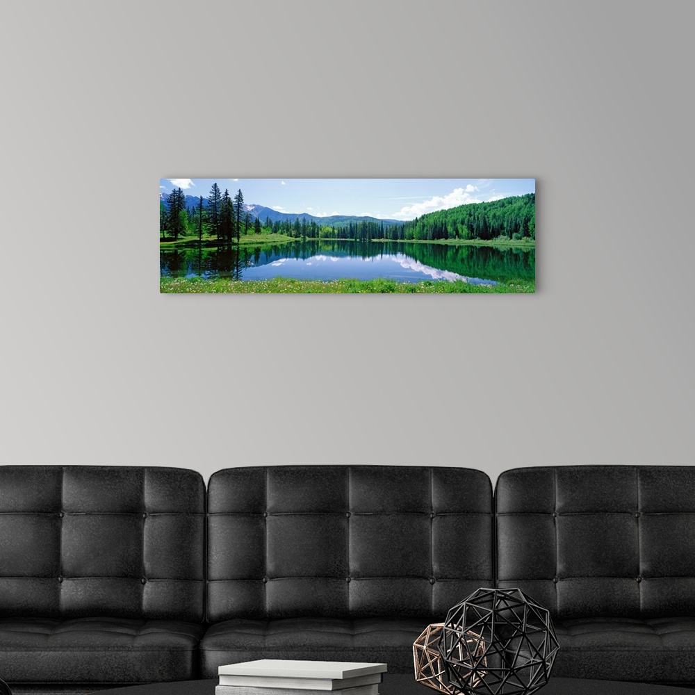 A modern room featuring The still waters of a Colorado lake reflect the trees and clouds in this panoramic landscape phot...