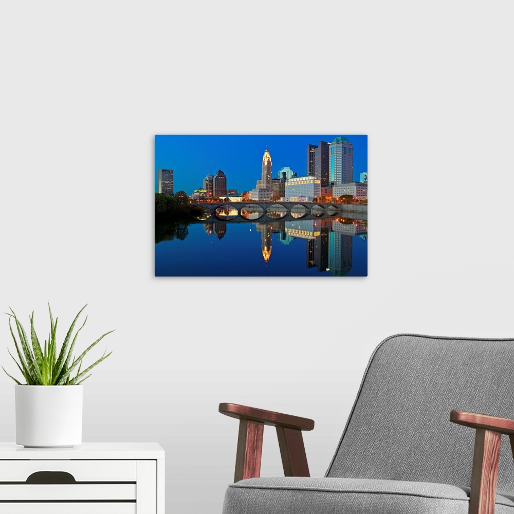 A modern room featuring Scioto River and Columbus Ohio skyline at dusk