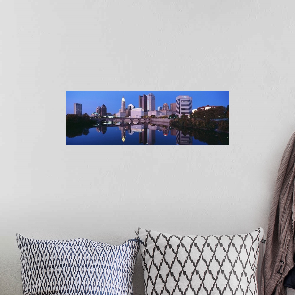 A bohemian room featuring Scioto River and Columbus Ohio skyline, the capital city, at dusk with lights on