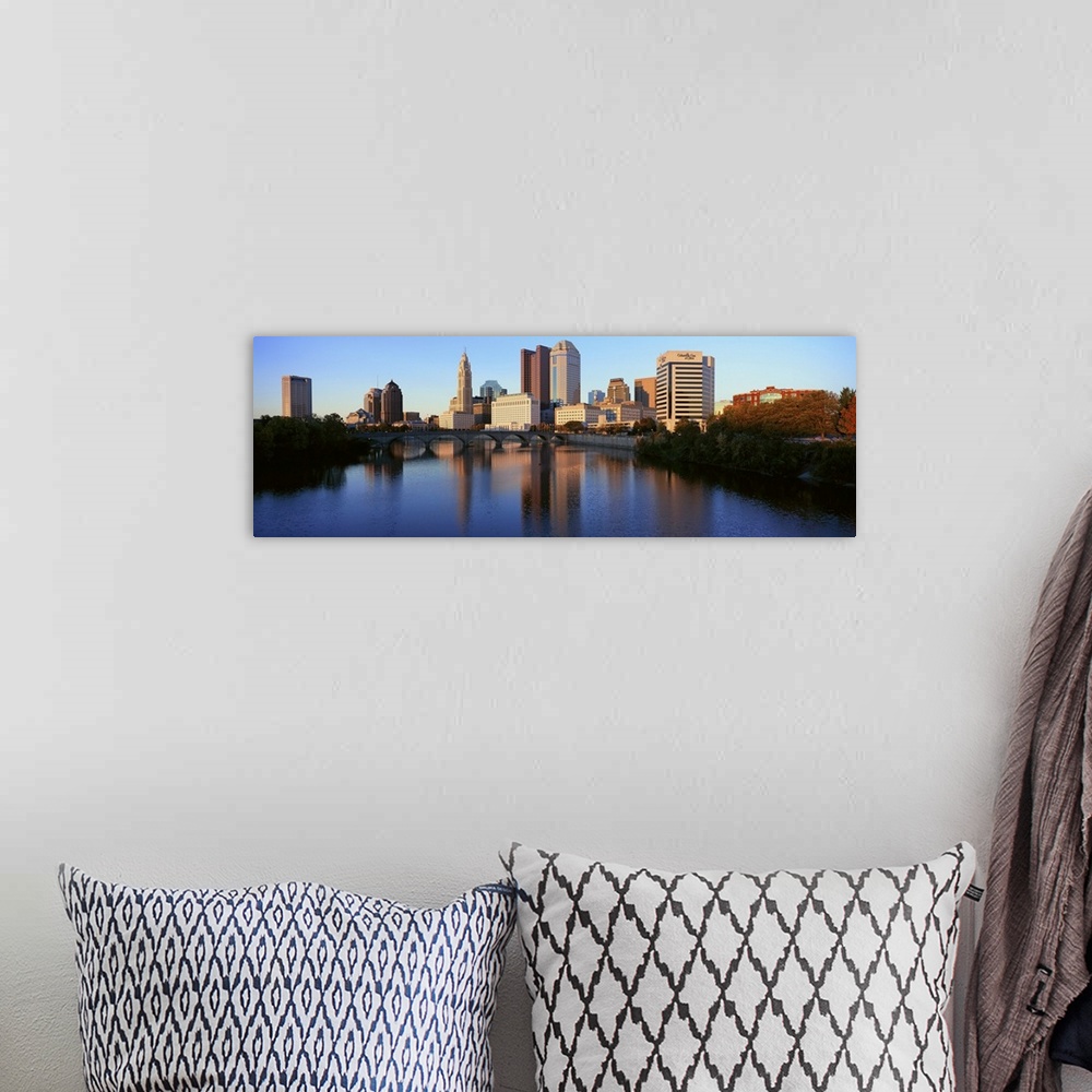 A bohemian room featuring Scioto River and Columbus Ohio skyline, with setting sunlight