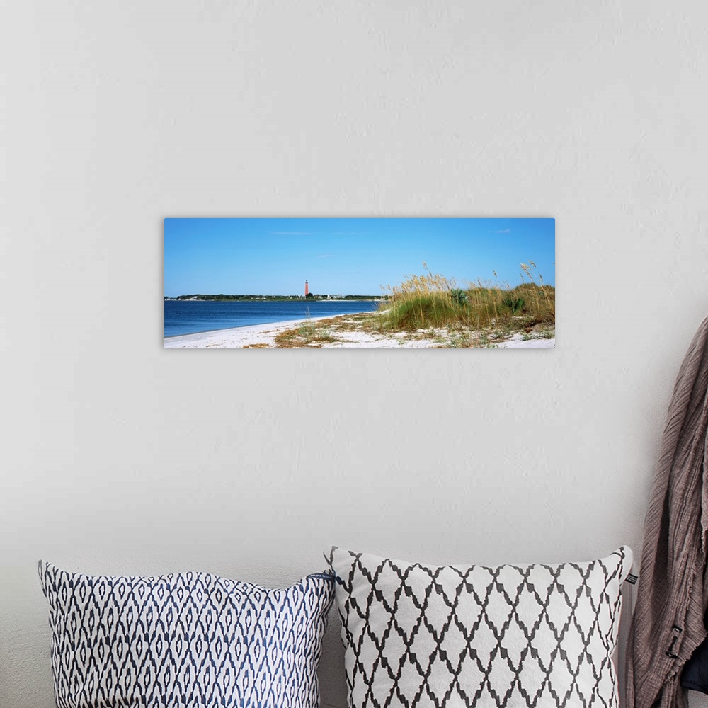 A bohemian room featuring Sea oat grass on beach with Ponce de Leon Inlet Lighthouse in the background, Smyrna Dunes Park, ...