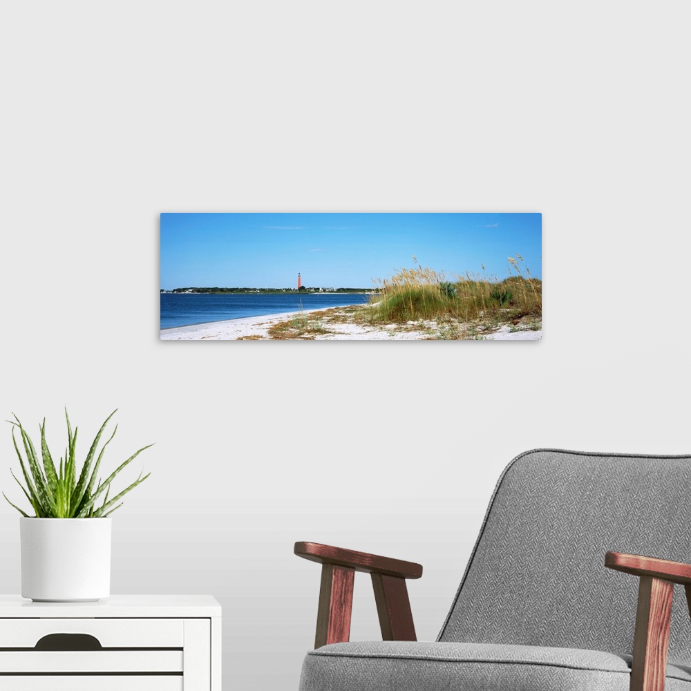 A modern room featuring Sea oat grass on beach with Ponce de Leon Inlet Lighthouse in the background, Smyrna Dunes Park, ...
