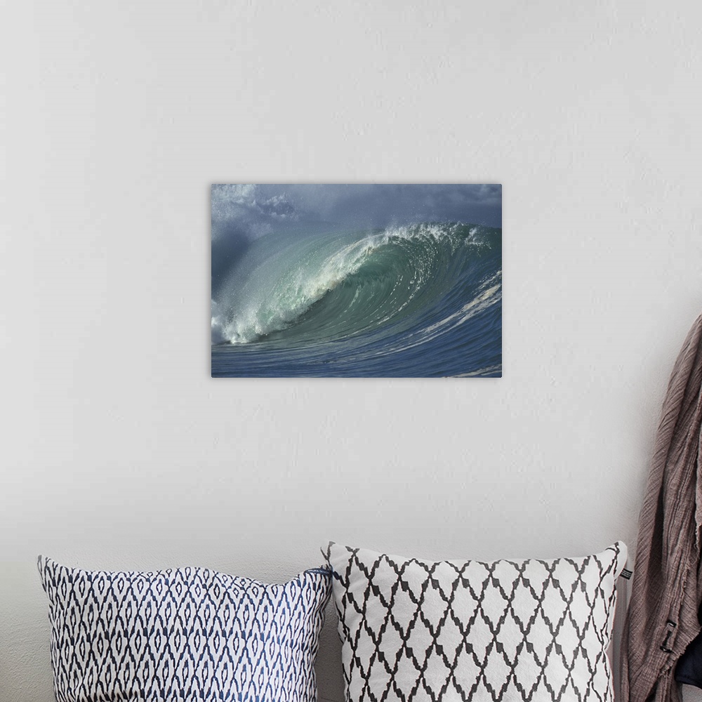 A bohemian room featuring Photograph taken of a massive wave that is beginning to curve and crash in the ocean.