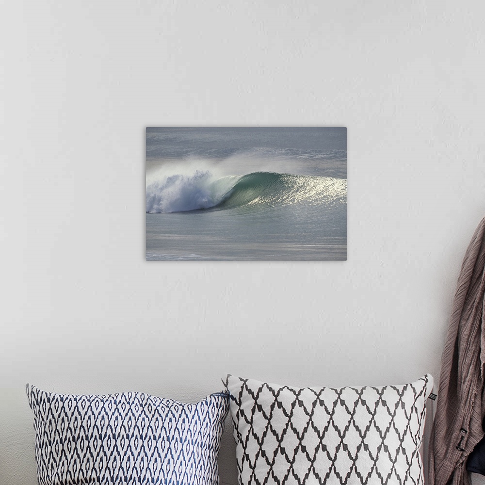 A bohemian room featuring This landscape photograph shows an ocean wave breaking on the shore.