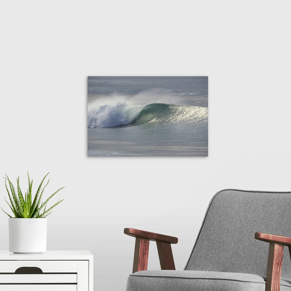 A modern room featuring This landscape photograph shows an ocean wave breaking on the shore.