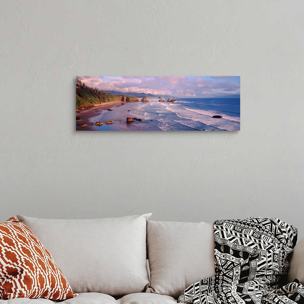 A bohemian room featuring Panoramic photograph of waves slowly crashing against the rocks and sand of Cannon Beach in Orego...