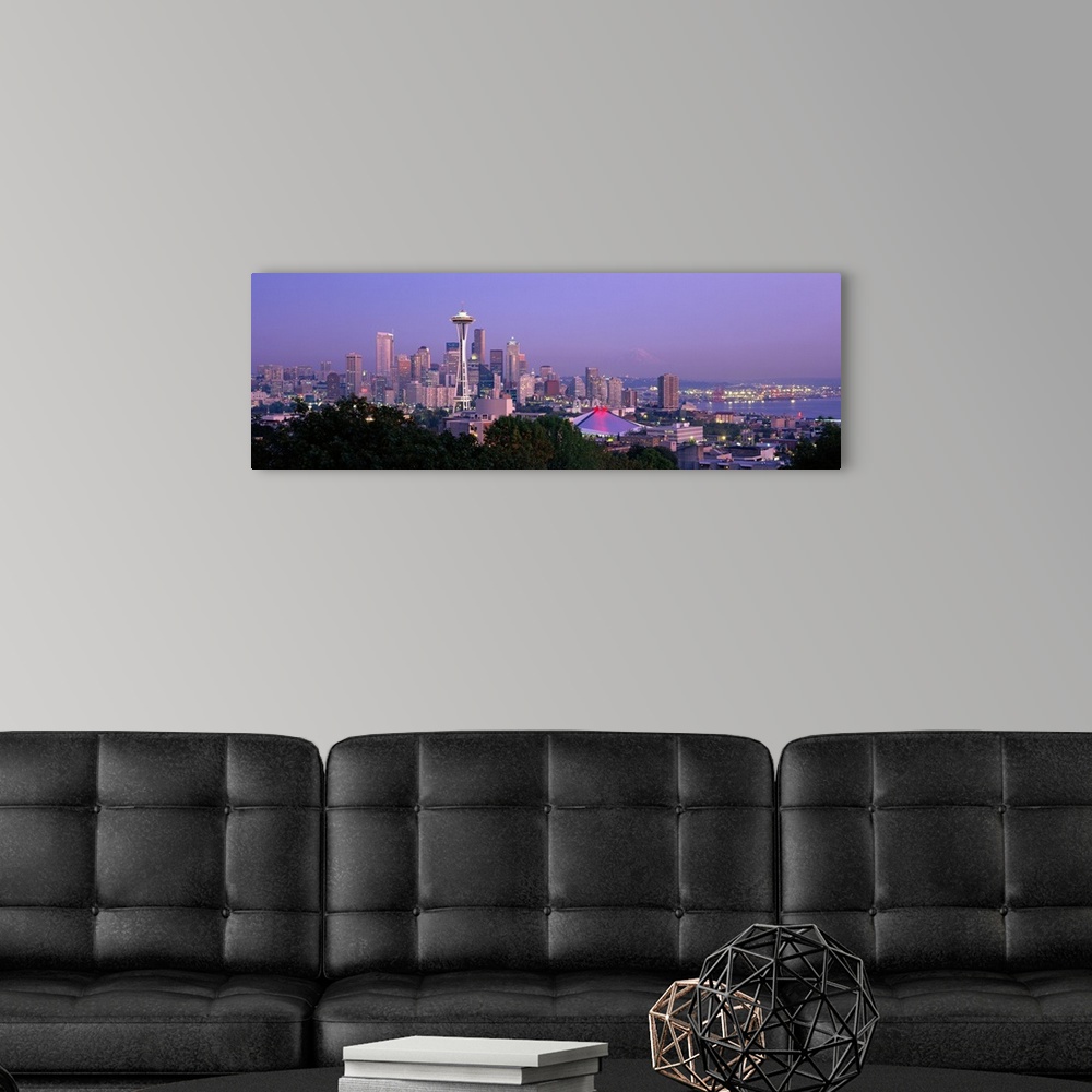 A modern room featuring Panoramic view of the Seattle, Washington skyline in the early evening, with the Space needle cle...