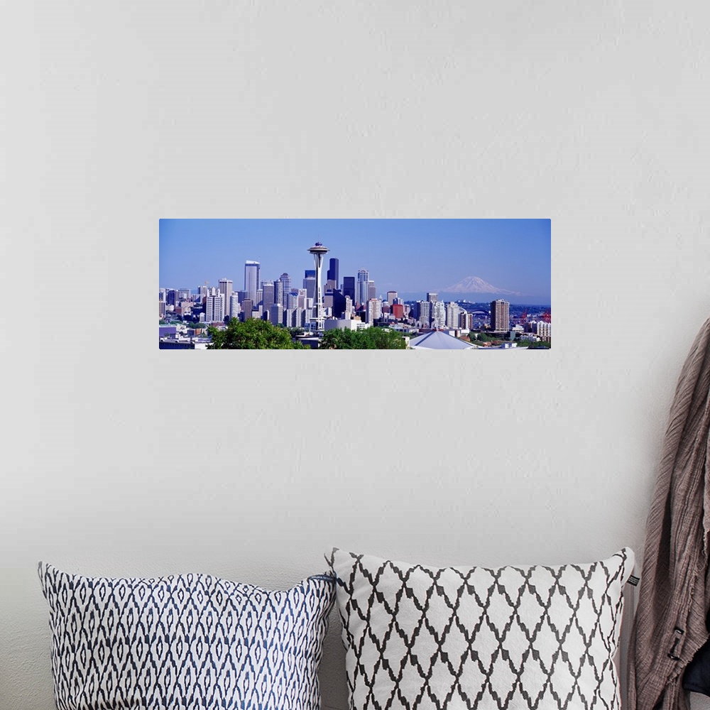 A bohemian room featuring Panoramic photograph shows the busy skyline for the most populated city in Washington state.  In ...