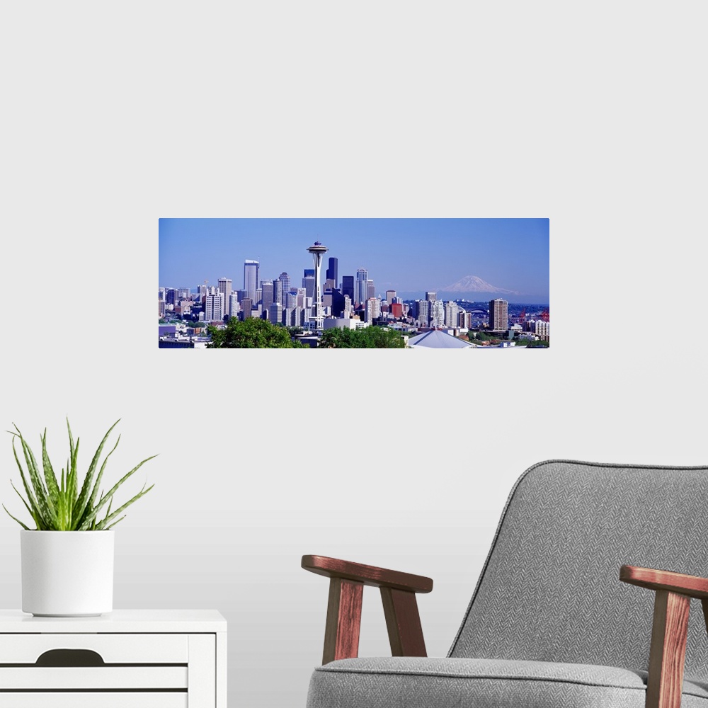 A modern room featuring Panoramic photograph shows the busy skyline for the most populated city in Washington state.  In ...
