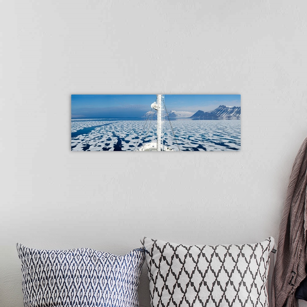 A bohemian room featuring Ship in the ocean with a mountain range in the background, Bellsund, Spitsbergen, Svalbard Island...