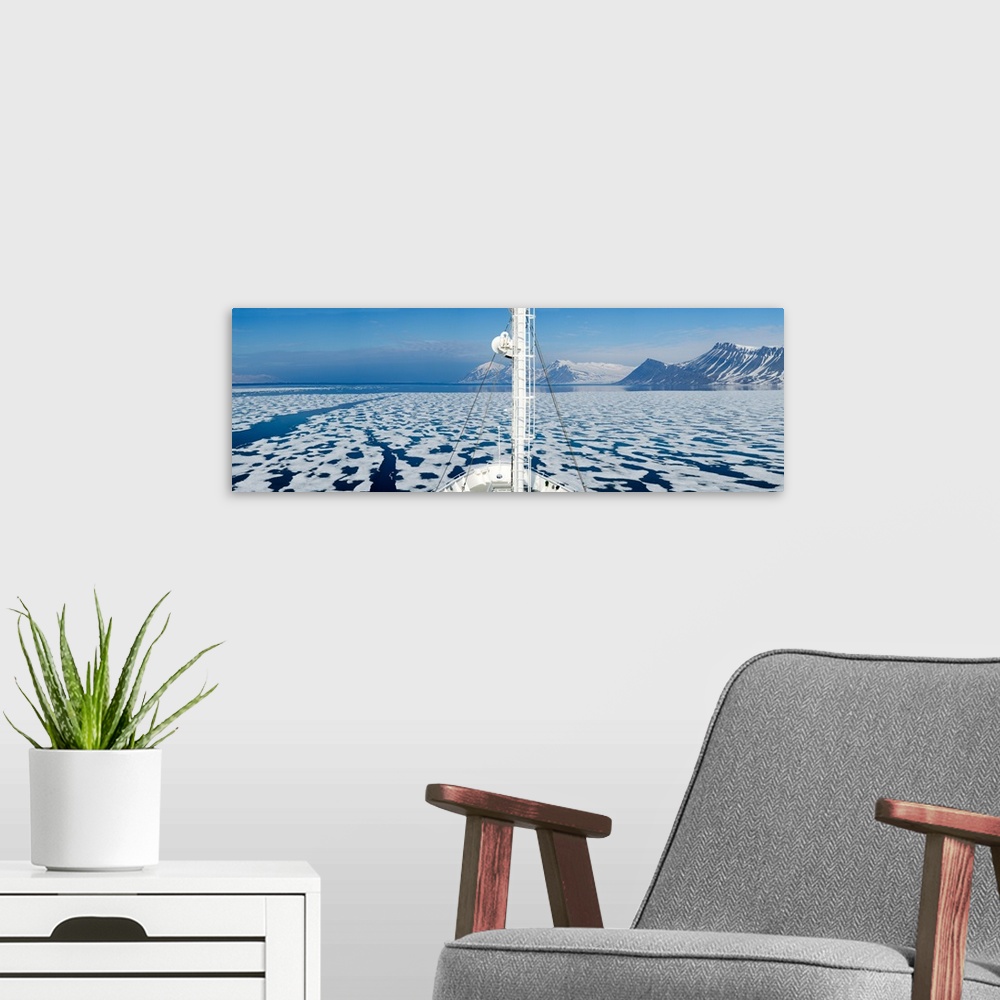 A modern room featuring Ship in the ocean with a mountain range in the background, Bellsund, Spitsbergen, Svalbard Island...