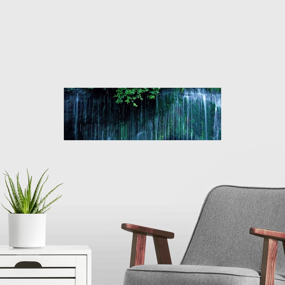 A modern room featuring Panoramic photo of little waterfalls trickling down a cliff in Japan.