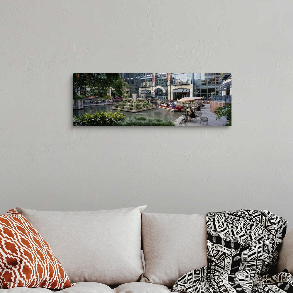 A bohemian room featuring Oversized photograph on a horizontal canvas of the Rivercenter mall in San Antonio, Texas.  A sma...