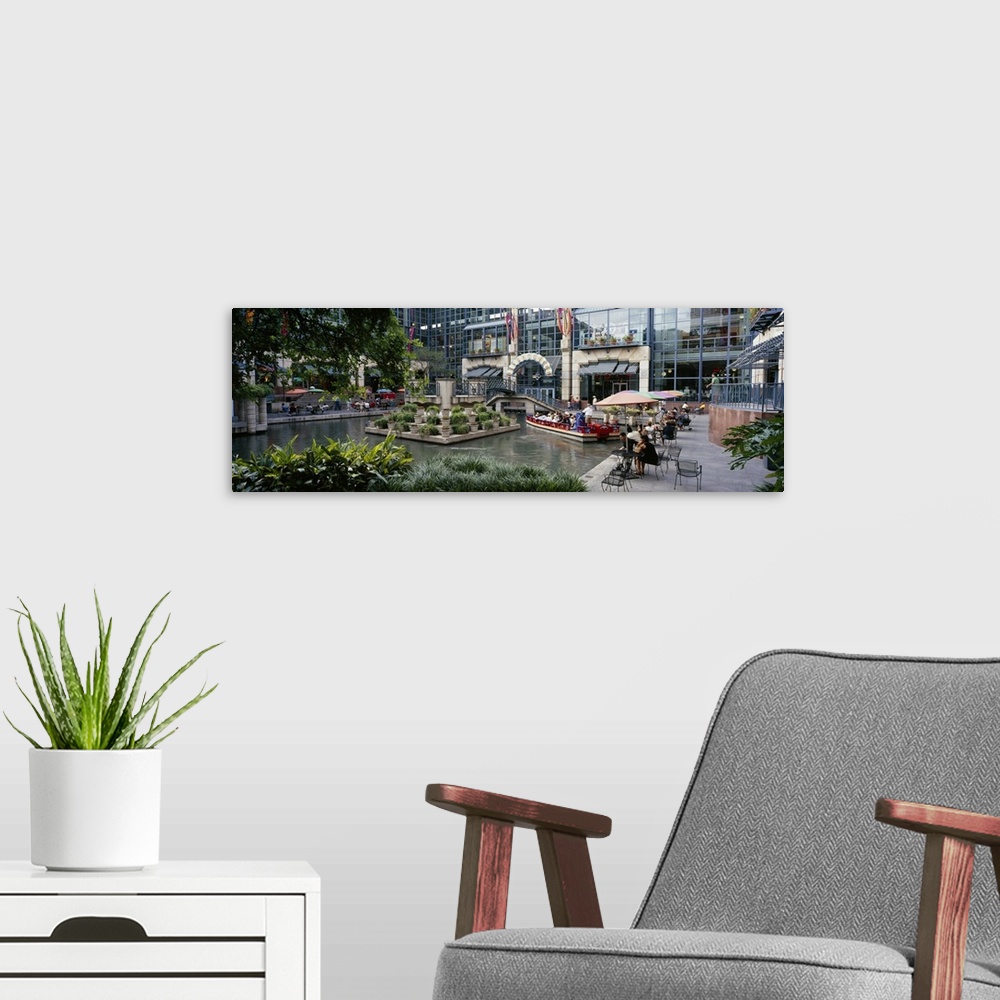 A modern room featuring Oversized photograph on a horizontal canvas of the Rivercenter mall in San Antonio, Texas.  A sma...