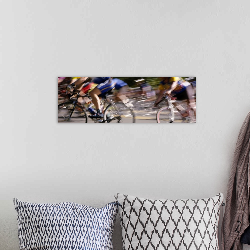 A bohemian room featuring A panoramic photograph of racers on bicycles moving through the frame, blurred with motion.