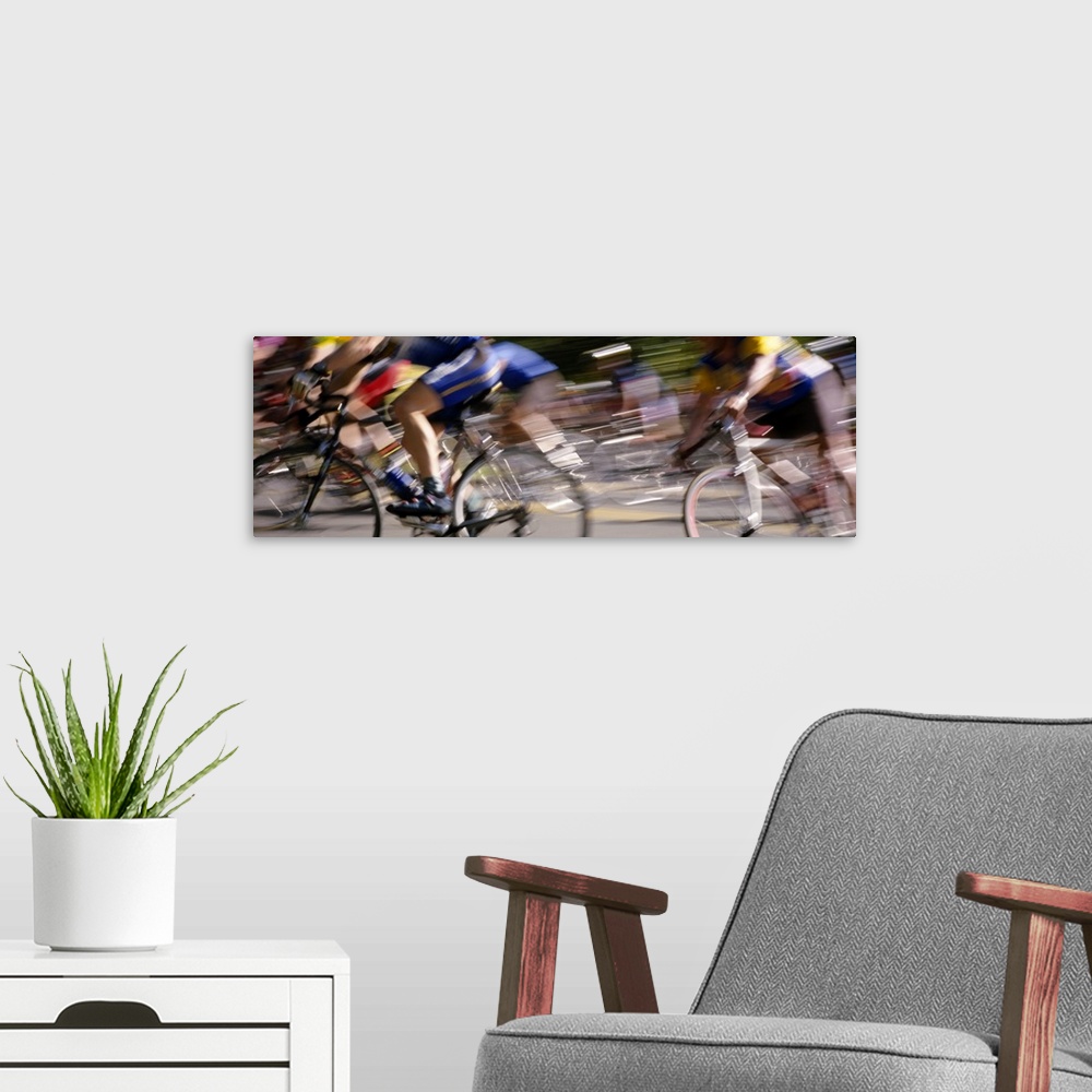 A modern room featuring A panoramic photograph of racers on bicycles moving through the frame, blurred with motion.