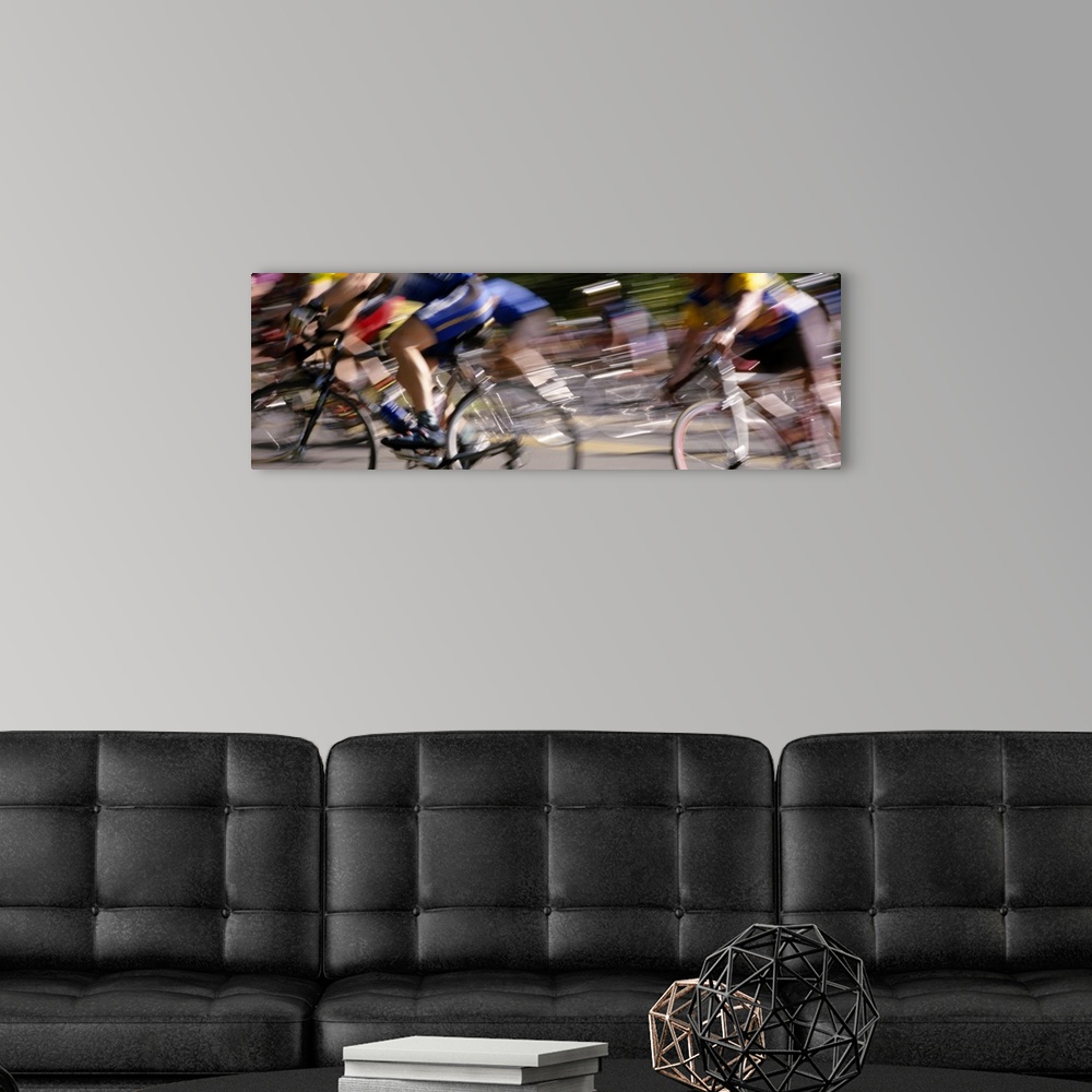 A modern room featuring A panoramic photograph of racers on bicycles moving through the frame, blurred with motion.