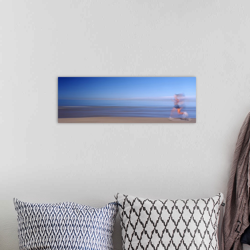 A bohemian room featuring Side profile of a woman running on the beach