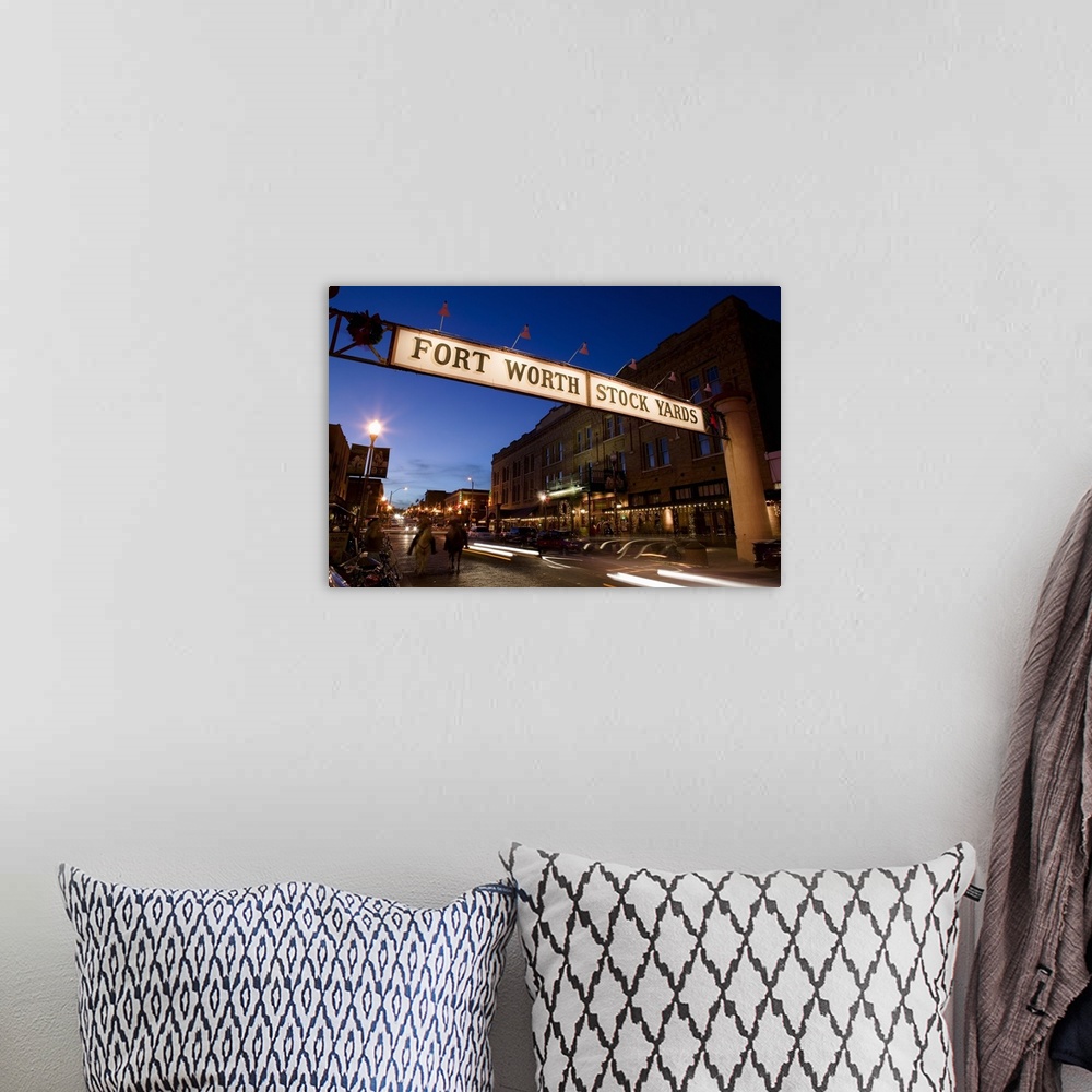 A bohemian room featuring Landscape photograph of the Fort Worth Stock Yards sign over a road lined with buildings, at dusk...