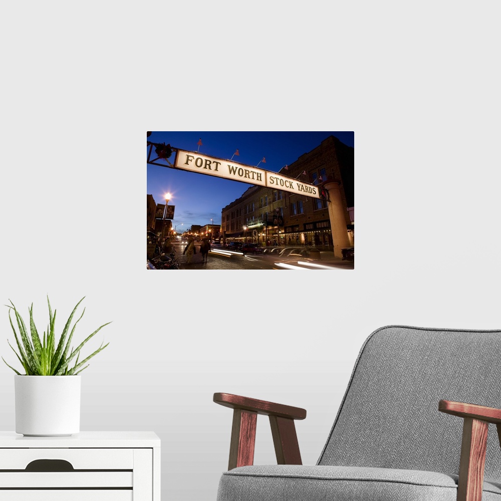 A modern room featuring Landscape photograph of the Fort Worth Stock Yards sign over a road lined with buildings, at dusk...