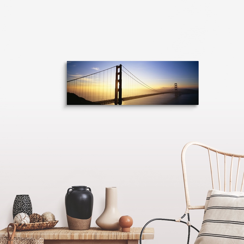A farmhouse room featuring Panoramic, angled photograph of the Golden Gate Bridge, silhouetted as the sun rises in the sky o...