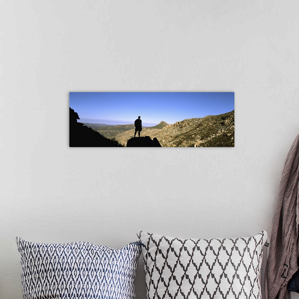 A bohemian room featuring Silhouette of a hiker standing on a rock, Cederberg Mountains, South Africa