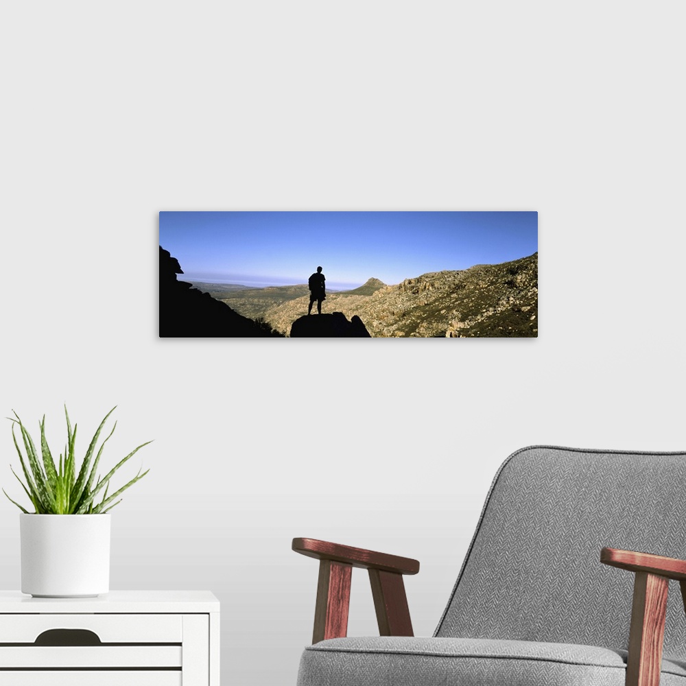 A modern room featuring Silhouette of a hiker standing on a rock, Cederberg Mountains, South Africa