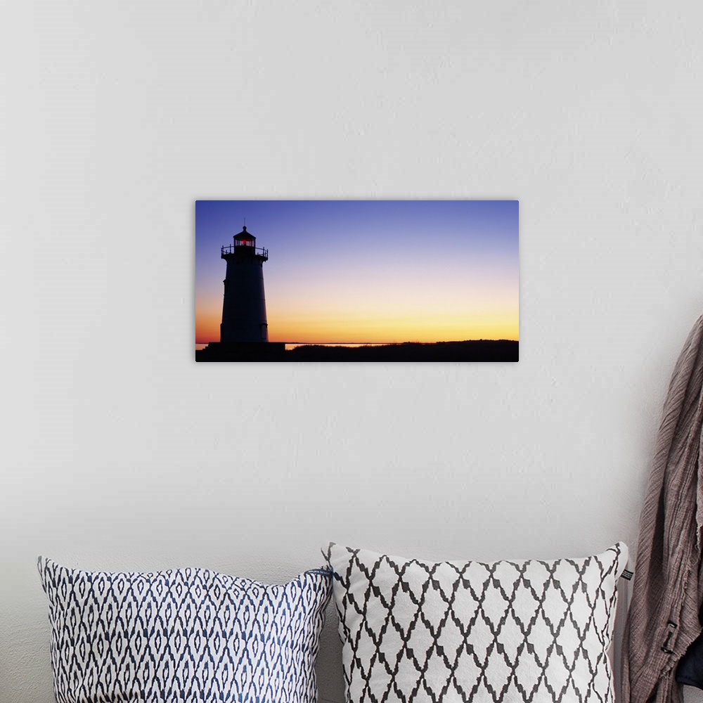 A bohemian room featuring Wall docor of the silhouette of a lighthouse against a bright sunset.
