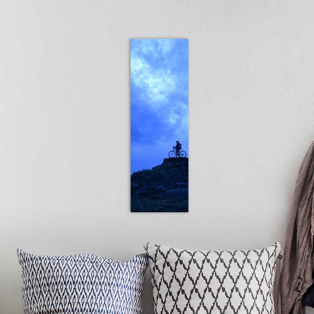 A bohemian room featuring Silhouette of a mountain biker standing on a cliff, Kansas