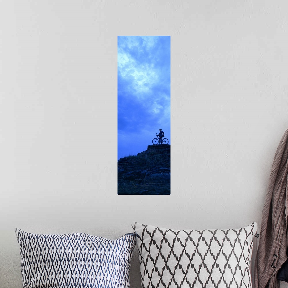 A bohemian room featuring Silhouette of a mountain biker standing on a cliff, Kansas