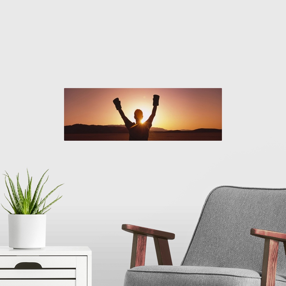 A modern room featuring Silhouette of a person wearing boxing gloves in a desert at dusk, Black Rock Desert, Nevada