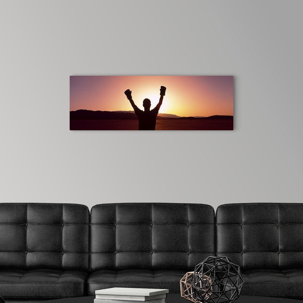 A modern room featuring Silhouette of a person wearing boxing gloves in a desert at dusk, Black Rock Desert, Nevada