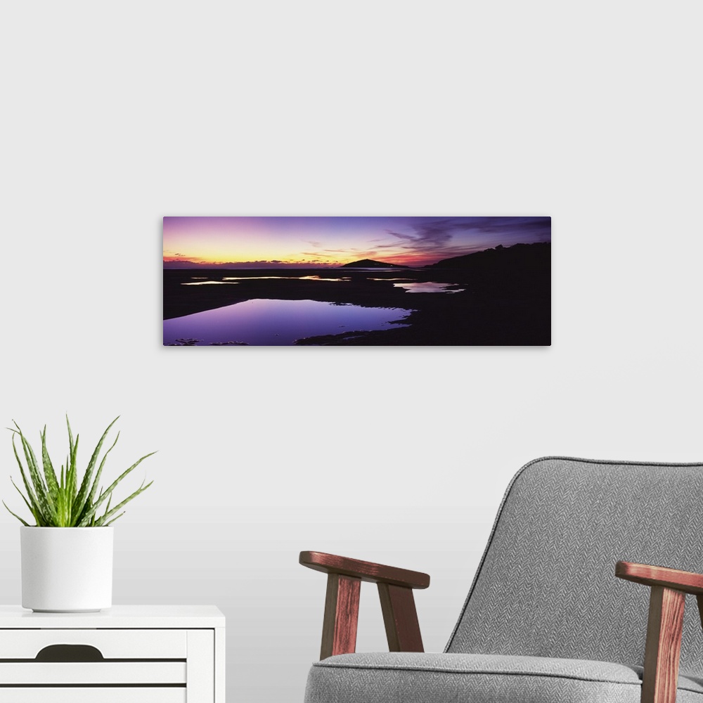 A modern room featuring Silhouette of an island at dusk, Burgh Island, Bantham Beach, South Devon, England