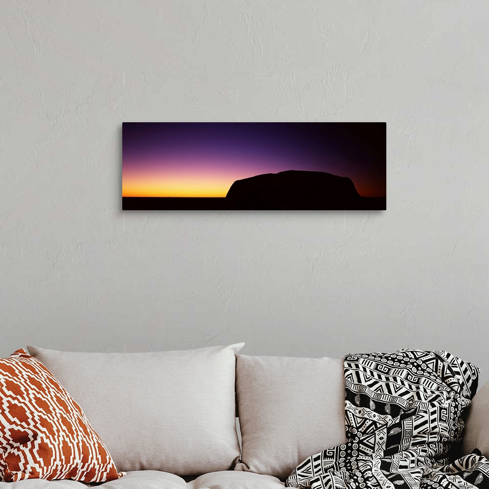 A bohemian room featuring Silhouette of Ayers Rock formations on a landscape, Northern Territory, Australia