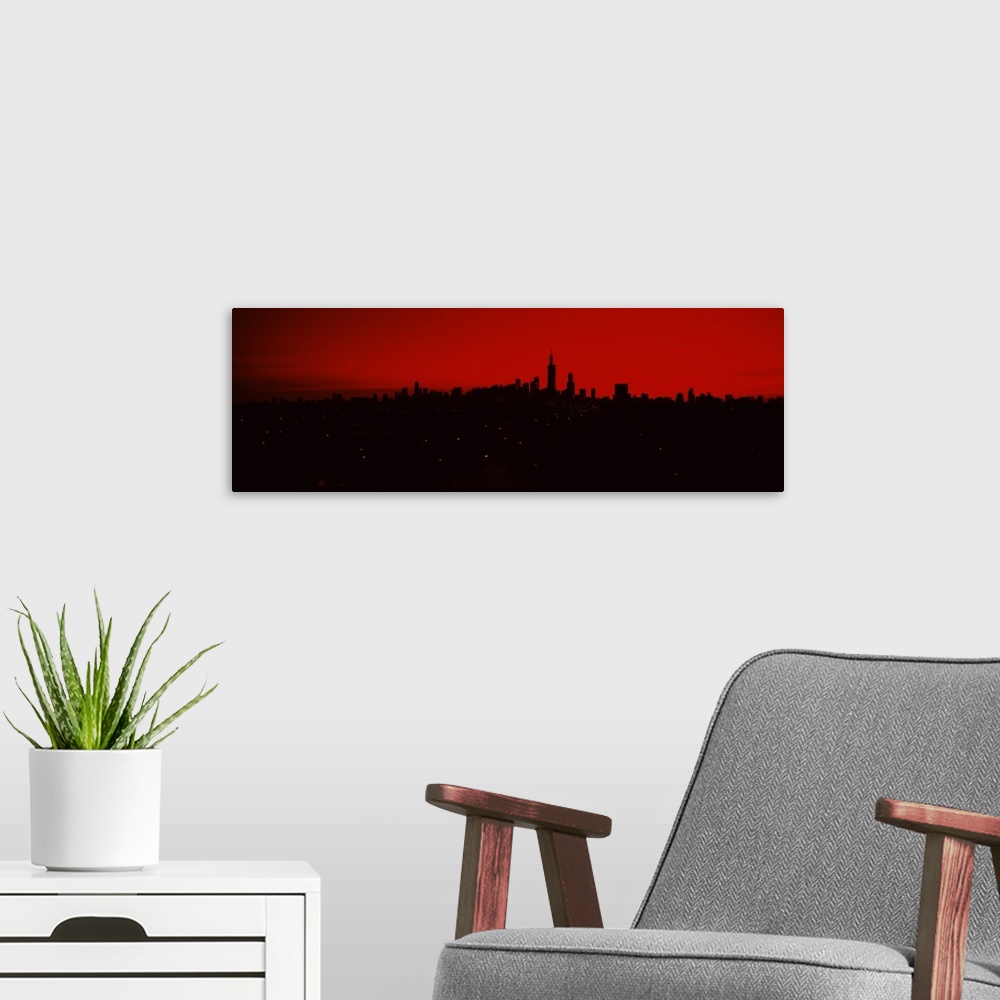 A modern room featuring Panoramic photo of a dark silhouetted cityscape against a warm sky.