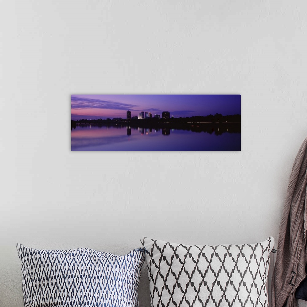 A bohemian room featuring Panoramic photograph taken of buildings sitting on the Arkansas river that are silhouetted by the...
