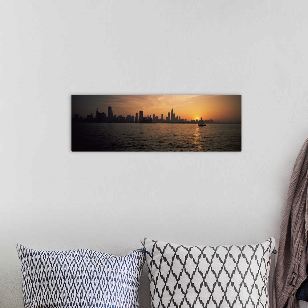 A bohemian room featuring Panoramic photograph on a large canvas of a silhouetted Chicago skyline on the horizon of Lake Mi...