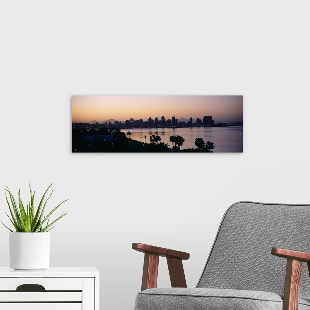 A modern room featuring Panoramic photograph taken from an aerial view overlooking the distant skyline of a busy city sit...