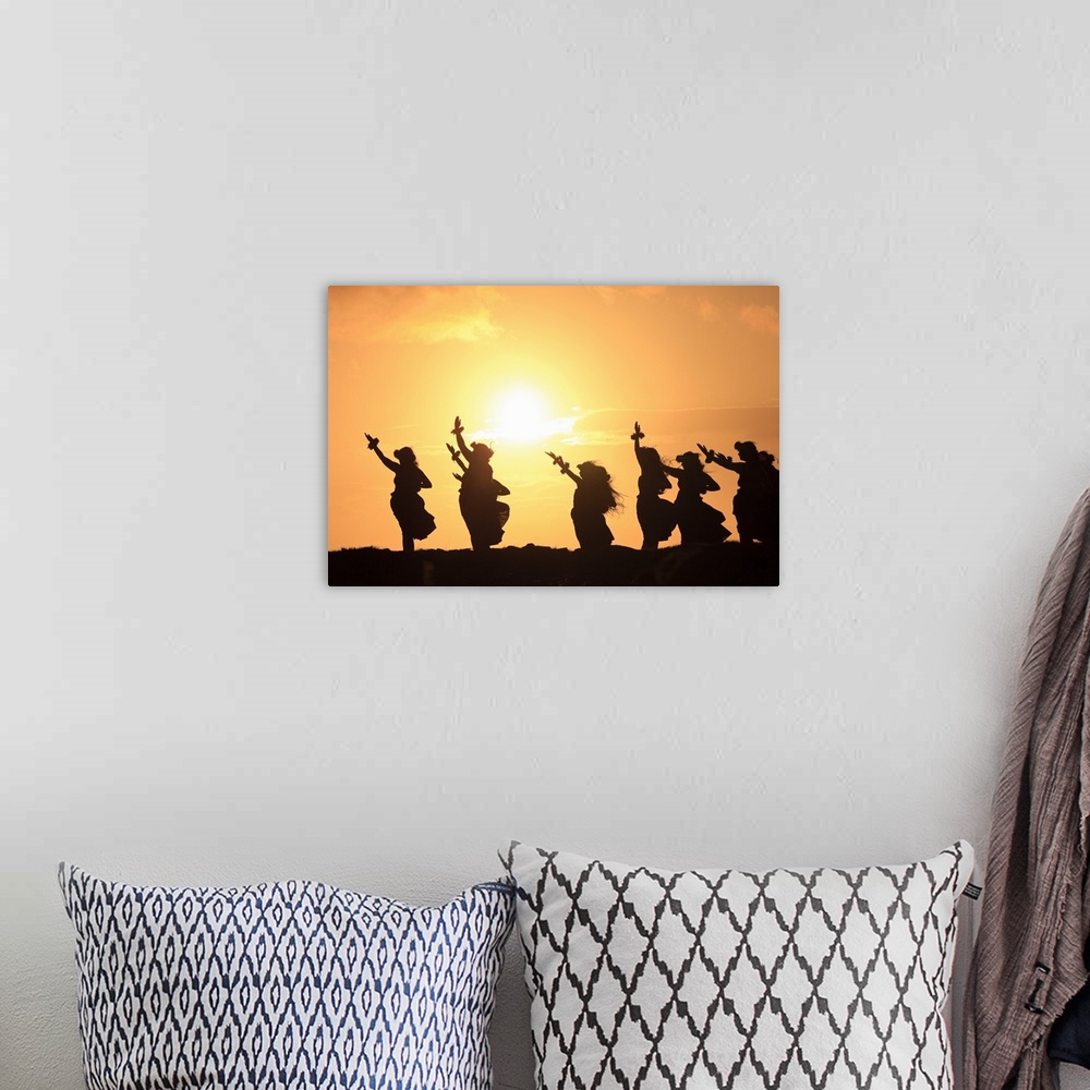 A bohemian room featuring Wall docor of hula dancers silohuetted against a rising sun.