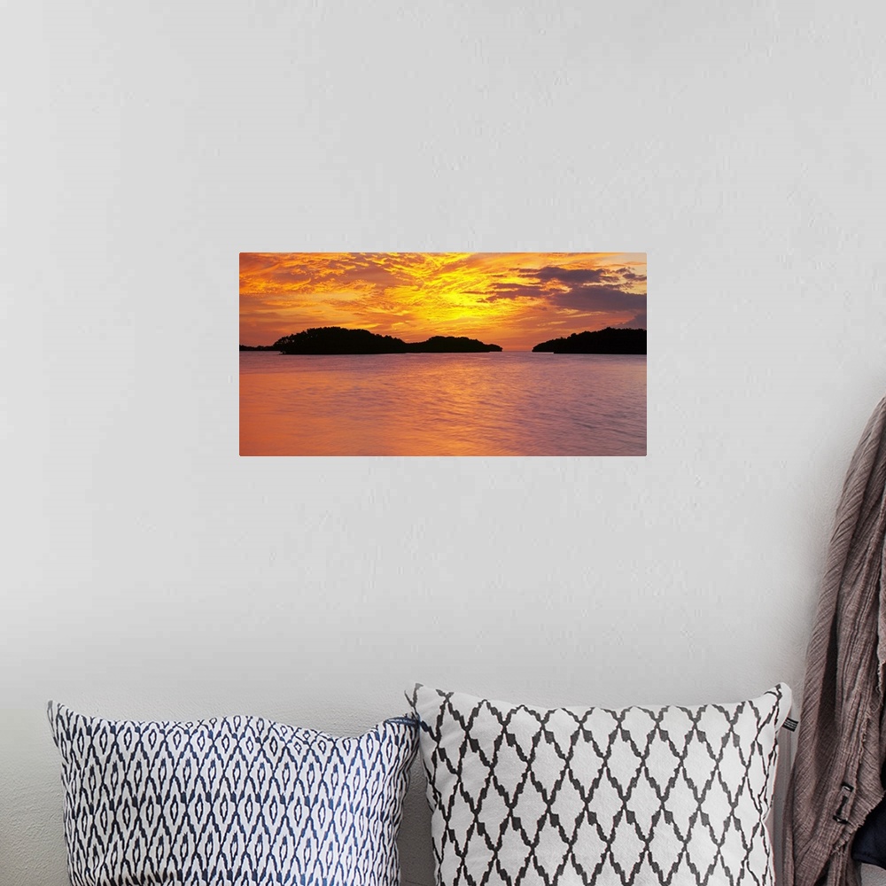 A bohemian room featuring Large canvas photo of a vibrant sunset reflected in calm waters.