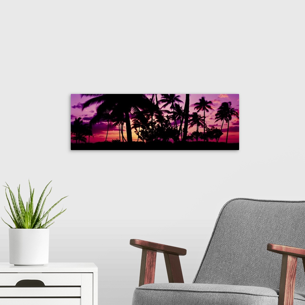 A modern room featuring Oversized, landscape photograph of a vivid sunset in Ko Olina, Oahu, Hawaii, with the silhouettes...