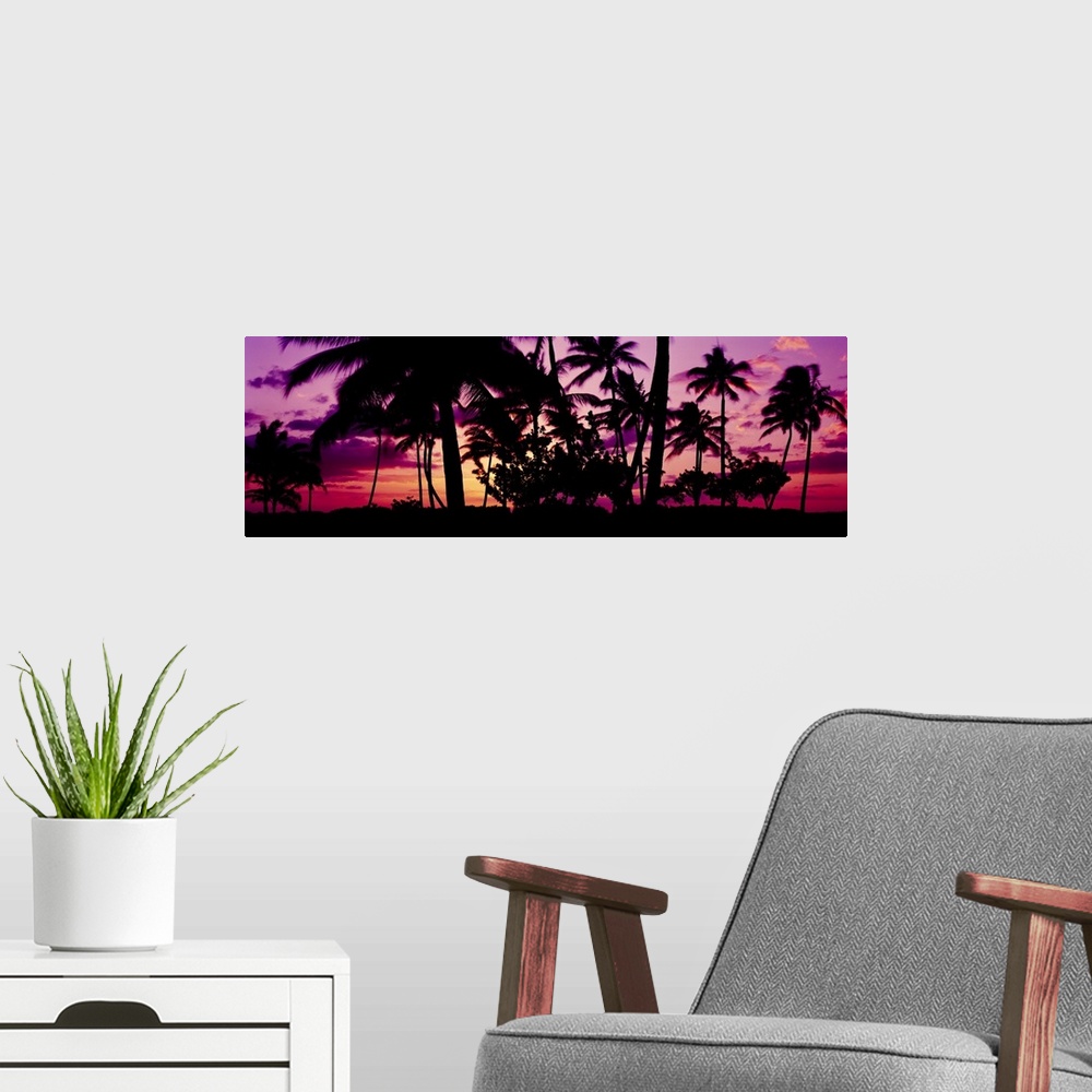 A modern room featuring Oversized, landscape photograph of a vivid sunset in Ko Olina, Oahu, Hawaii, with the silhouettes...