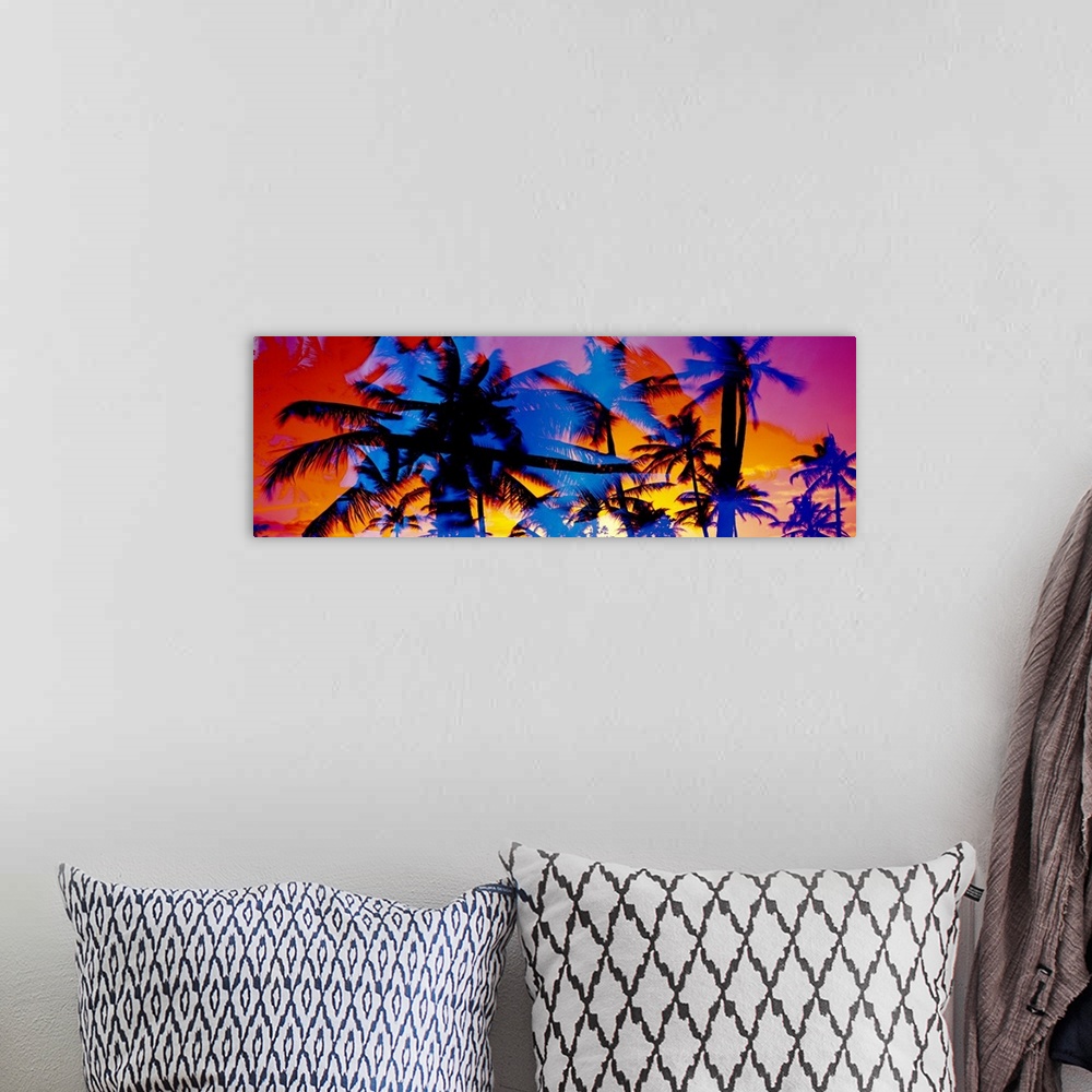 A bohemian room featuring Composite photo of several colored silhouettes of palm trees overlaid on each other, creating a c...
