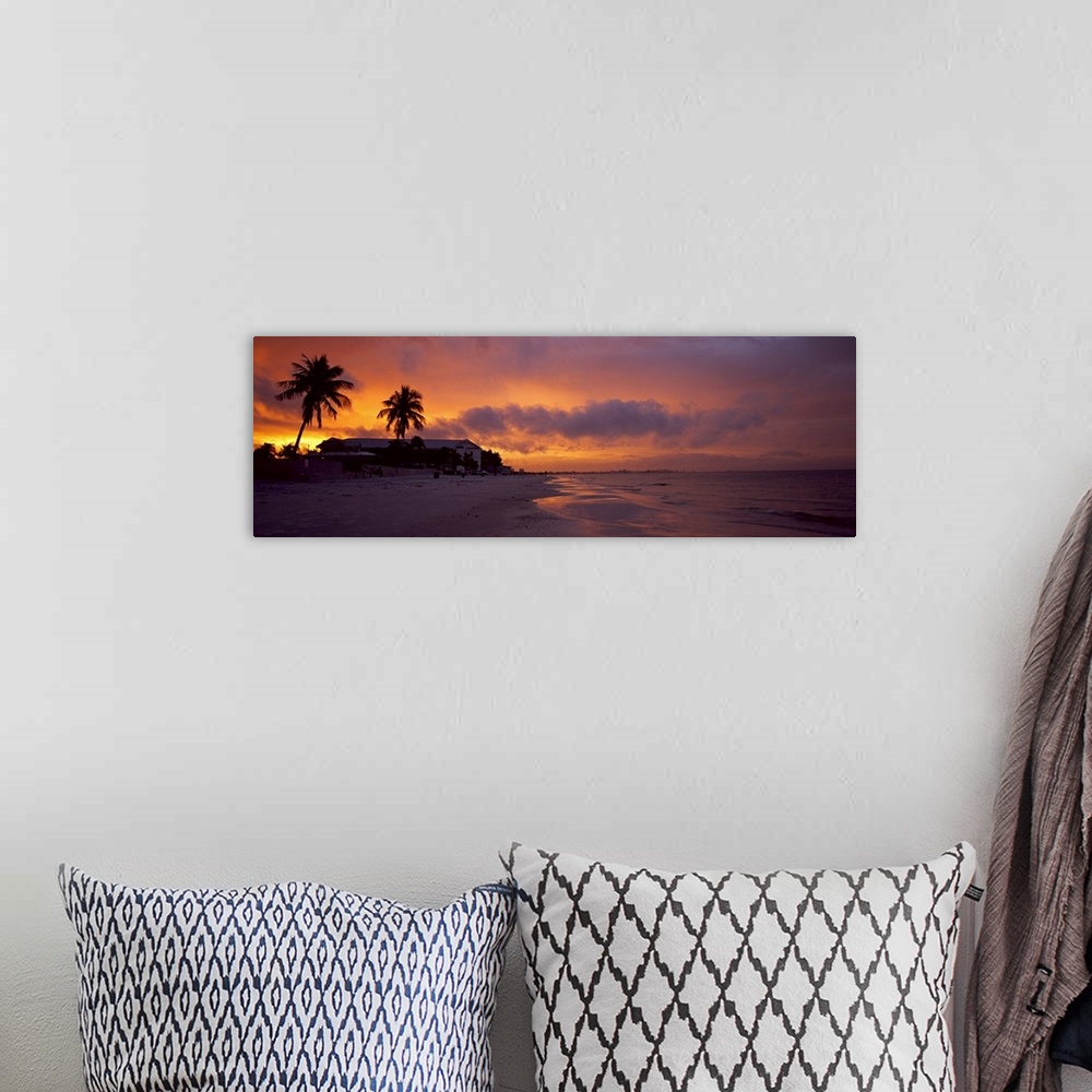 A bohemian room featuring Large panoramic photograph of a coast in Florida with the sun setting that turns the sky various ...