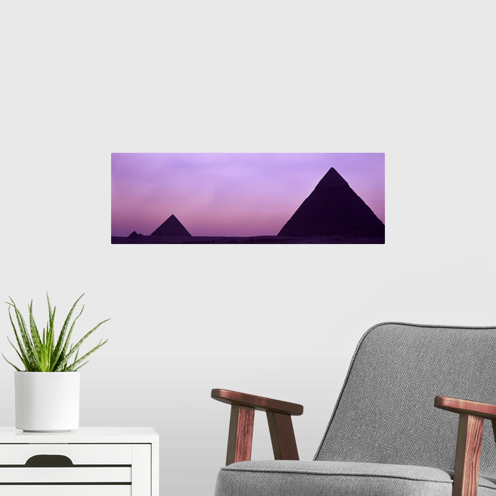 A modern room featuring Silhouette of pyramids at dusk, Giza, Egypt