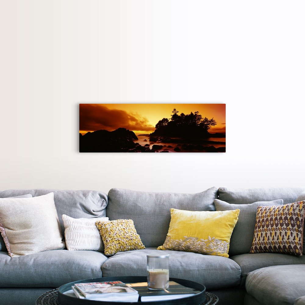 A farmhouse room featuring Panoramic photograph displays a sunburnt sky as the sun begins to set over the profile of a rocky...